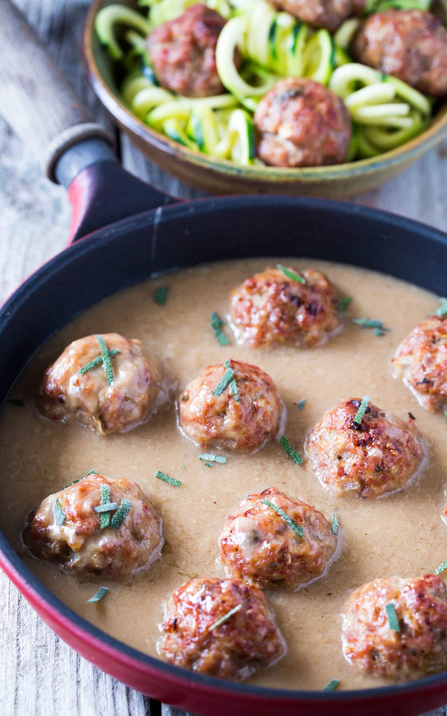 Easy Whole30 sage and onion Paleo Meatballs with Creamy Dairy Free Gravy made with coconut milk, served with zucchini noodles (zoodles)