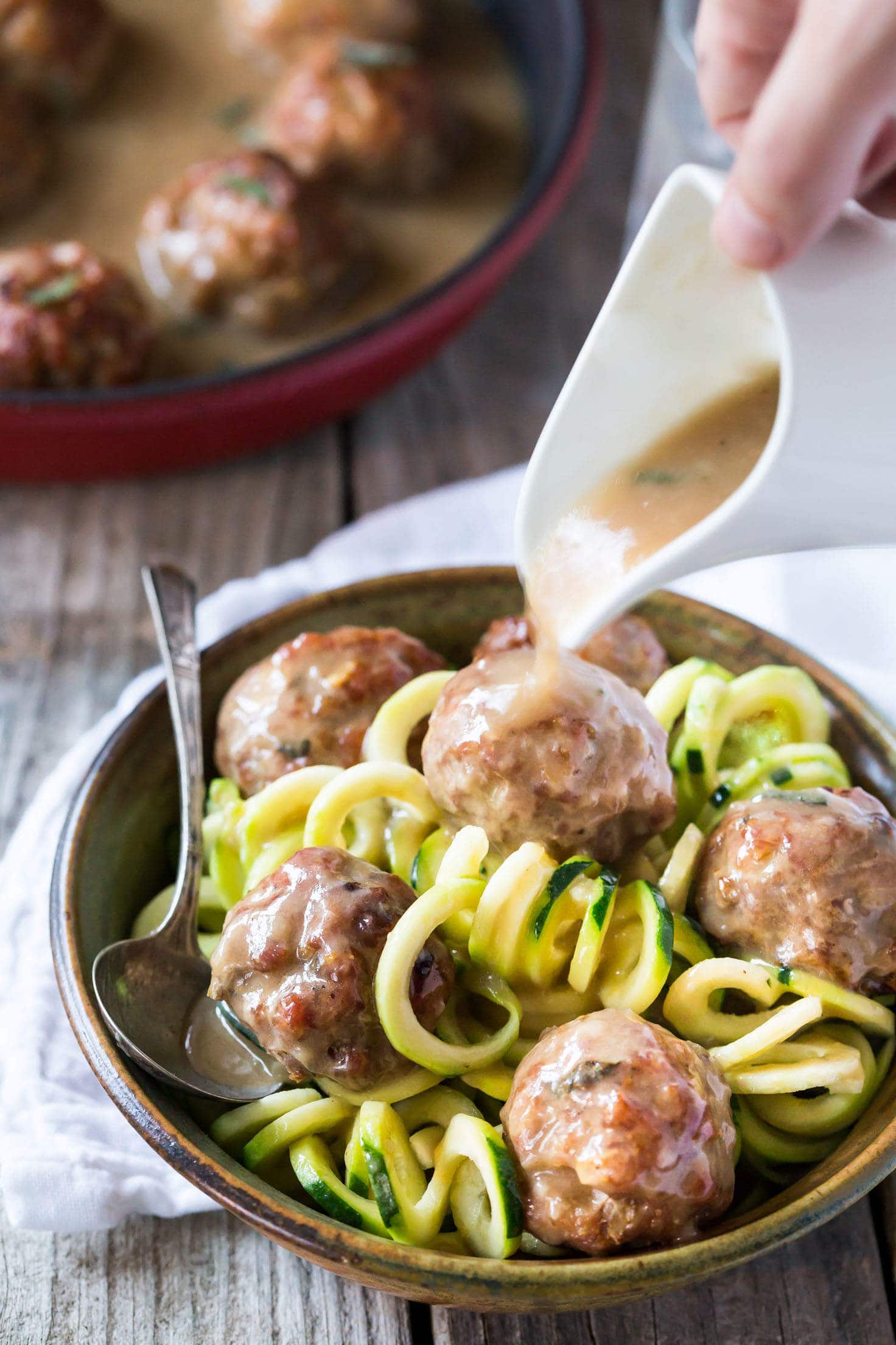 Easy Whole 30 sage and onion Paleo Meatballs with Creamy Dairy Free Gravy made with coconut milk, served with zucchini noodles (zoodles)