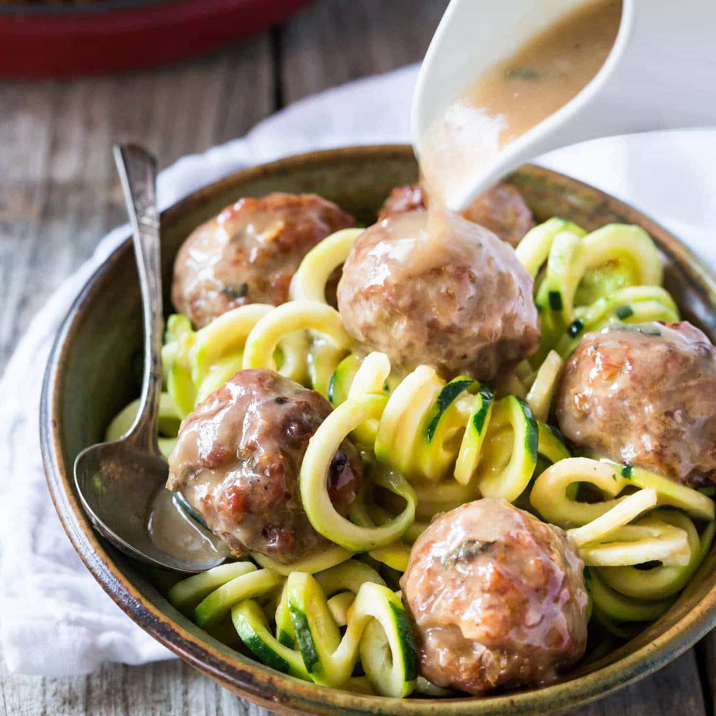 Easy Paleo Whole 30 sage and onion Meatballs with Creamy Dairy Free Gravy made with coconut milk, served with zucchini noodles (zoodles)