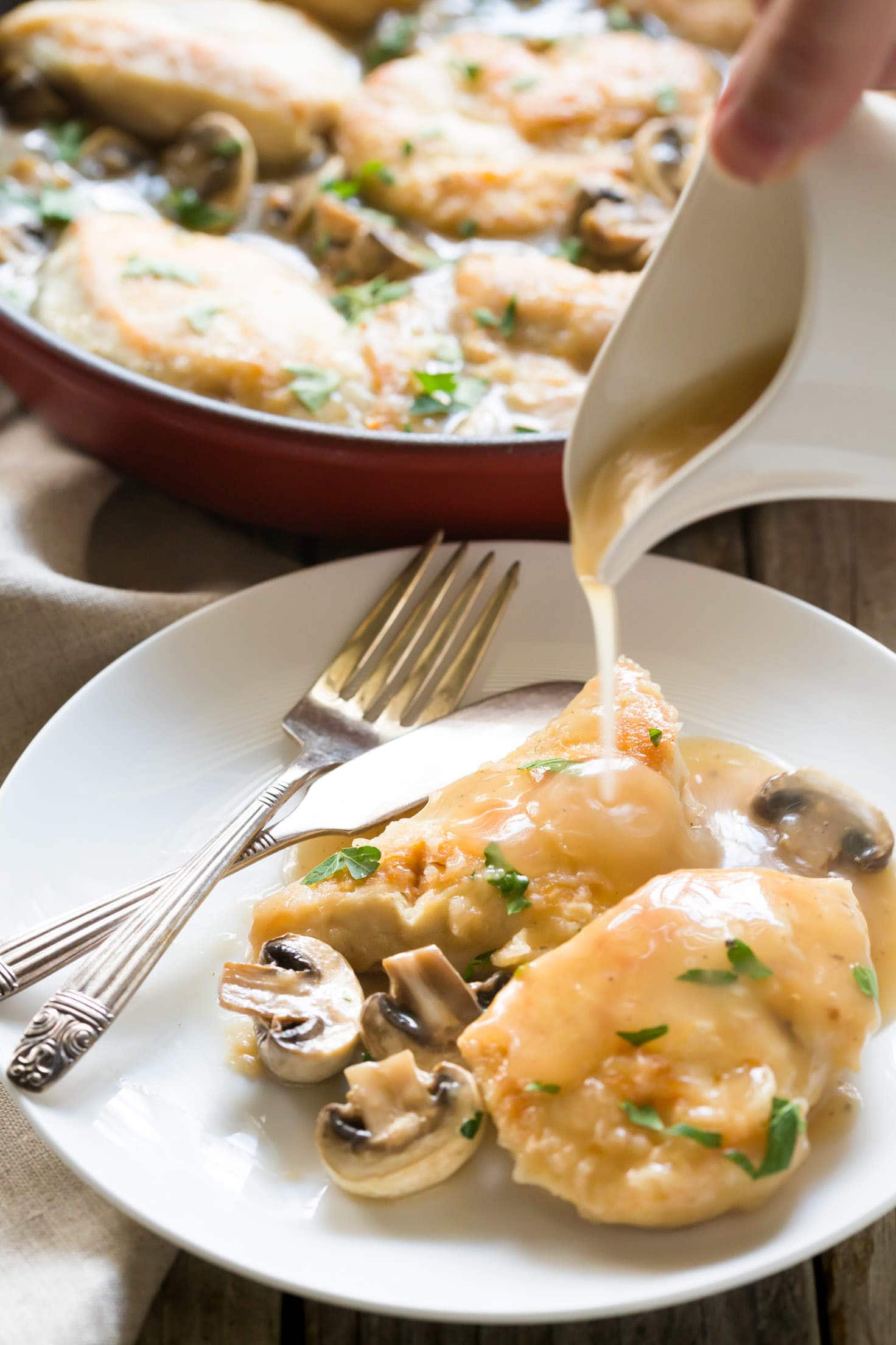 30 Minute Paleo Chicken Marsala recipe made with chicken, mushrooms, marsala wine, chicken broth and garnished with parsley. Thickened with arrowroot (or use cornstarch if you are not paleo) and you can serve it over mashed potatoes or zoodles