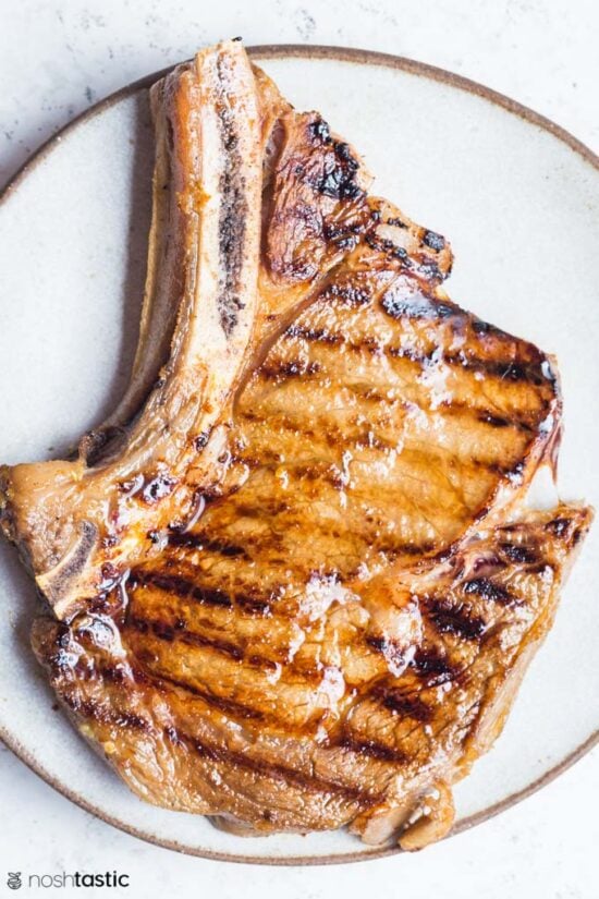 Cooked steak on a plate with grill marks