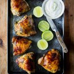 Easy Baked Cilantro Lime Chicken with Garlic! Made with a Cilantro, Honey, Allspice, Lime, Chili Flakes and Garlic marinade, this is a Paleo recipe with a Whole 30 option.
