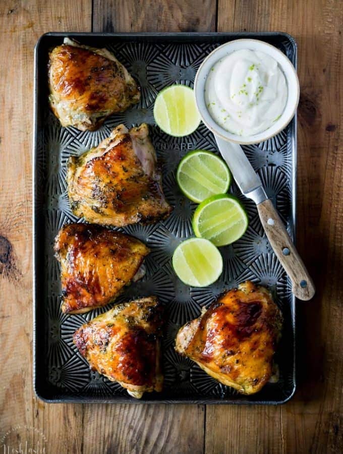 Easy Baked Cilantro Lime Chicken with Garlic! Made with a Cilantro, Honey, Allspice, Lime, Chili Flakes and Garlic marinade, this is a Paleo recipe with a Whole 30 option.