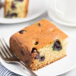 slice of gluten free blueberry cake on a white plate