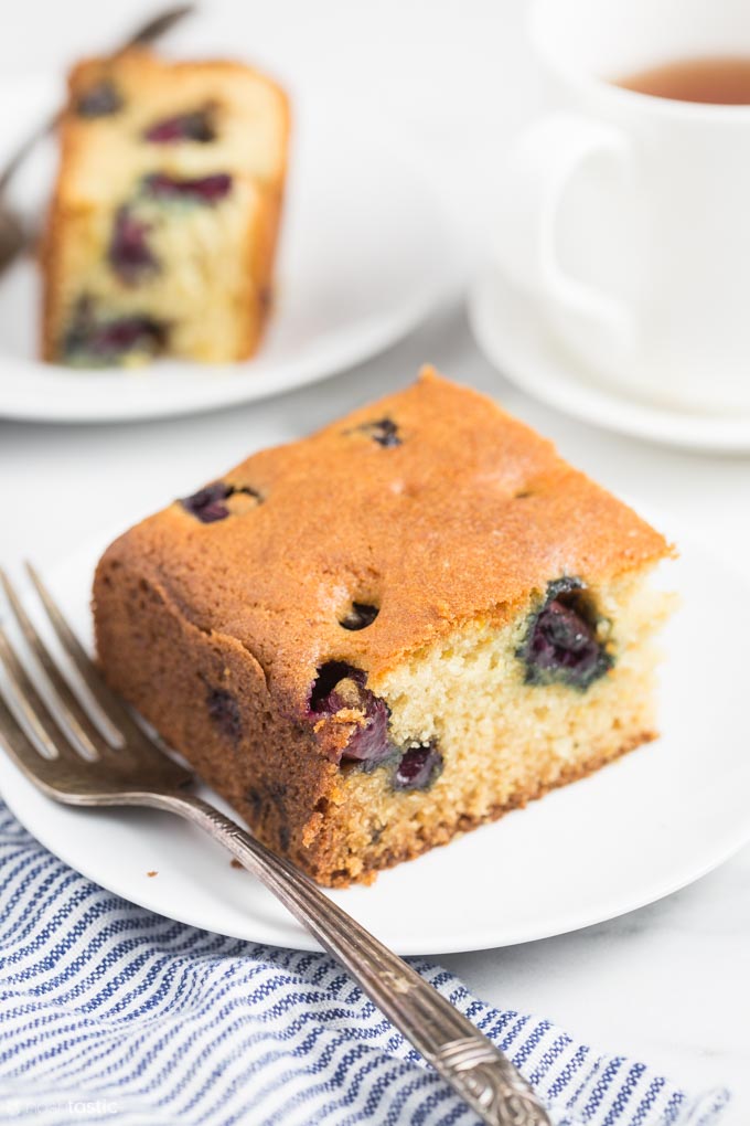 slice of gluten free blueberry cake on a white plate