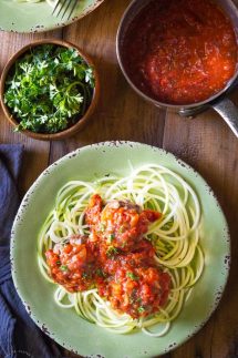 Paleo Italian Meatballs contain no breadcrumbs or grains of any kind. These beef and pork meatballs are baked in the oven and the Marinara sauce is made on the stove, from scratch, with tomatoes, onions, garlic and herbs #zoodles #spiralizer #spiralized #paderno #paleo #whole30 #w30 #paleomeatballs #paleodinner #paleomains #whole30dinner #whole30mains