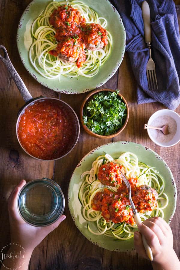 Paleo Italian Meatballs contain no breadcrumbs or grains of any kind. These beef and pork meatballs are baked in the oven and the Marinara sauce is made on the stove, from scratch, with tomatoes, onions, garlic and herbs #zoodles #spiralizer #spiralized #paderno #paleo #whole30 #w30 #paleomeatballs #paleodinner #paleomains #whole30dinner #whole30mains