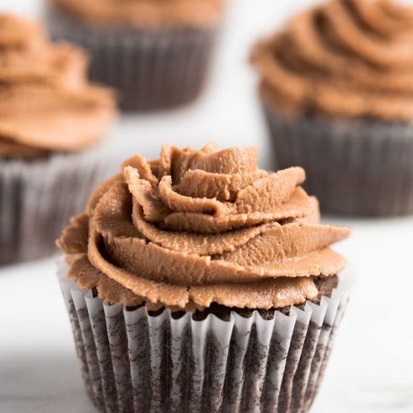 gluten free chocolate cupcake with chocolate frosting on a table