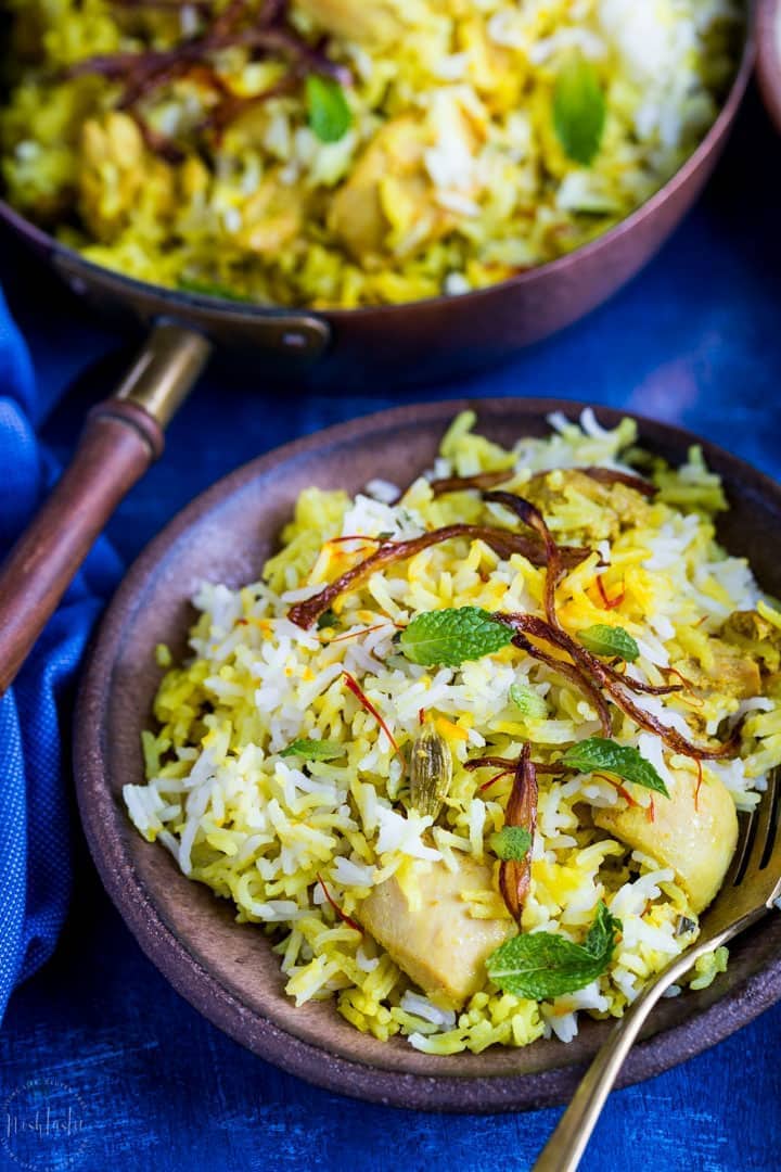 Easy Chicken Biryani made by layering rice, marinated chicken, onions and wonderfully fragrant spices. Healthy and Gluten Free.