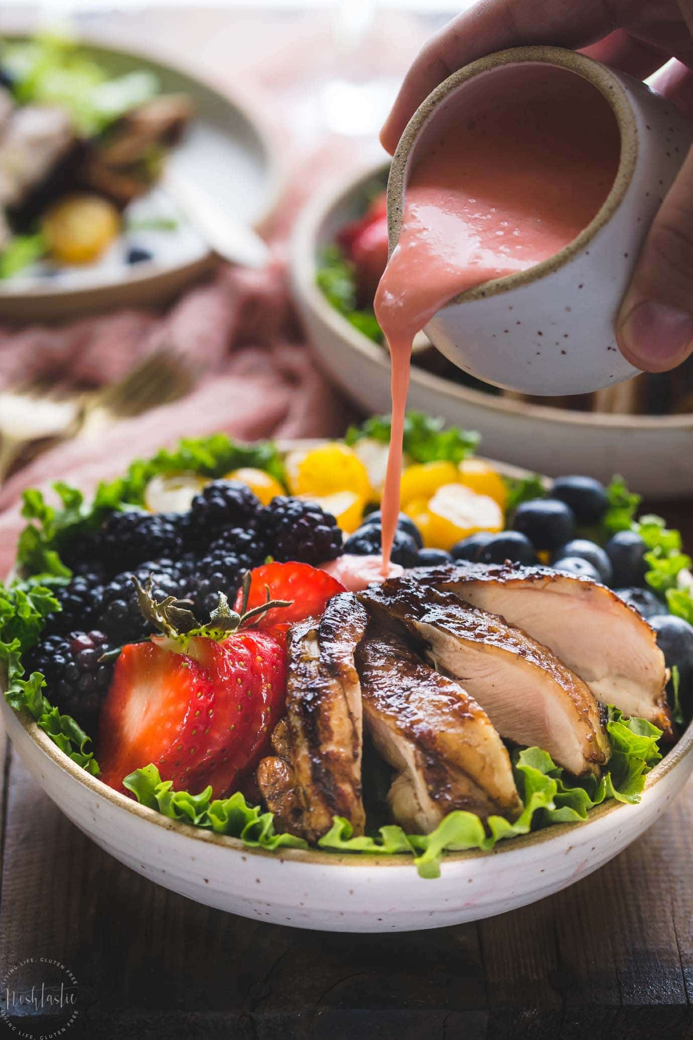 My Paleo Balsamic Chicken Salad is made with skinless chicken thighs marinated in balsamic vinegar, garlic, Dijon mustard and cooked to perfection on the grill before being served over a bed of lettuce with delicious Summer fruits and topped with a Creamy Dairy Free Strawberry Vinaigrette!