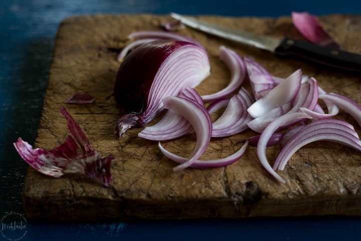 Chopped red onions on wood board