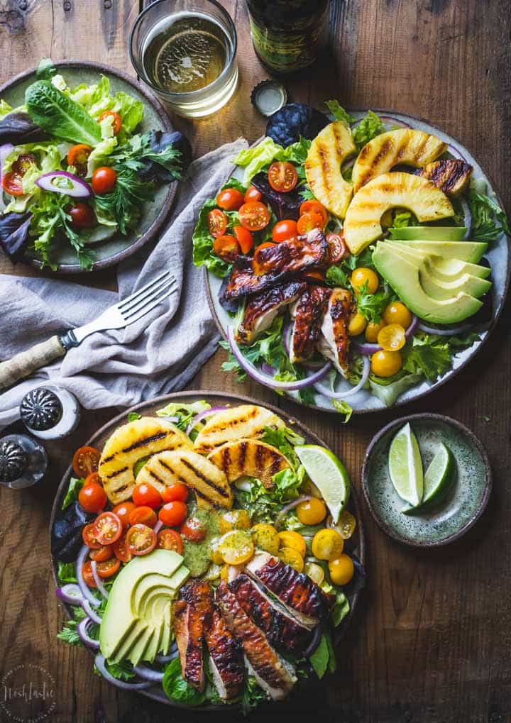 Cilantro Lime Chicken Salad, made with grilled pineapple, red onions, avocado, cherry tomatoes and served on a bed of lettuce. Healthy, Paleo and W30.