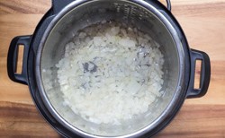 Onions cooking in a pressure cooker for soup