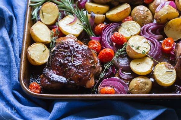 You need to try my delicious, easy, sheet pan Paleo Balsamic Chicken recipe with Roasted Potatoes, Red Onion, Tomatoes & fresh herbs! You can cook it on one pan in the oven in an hour or less!