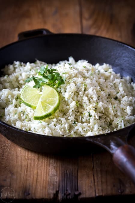 Cauliflower Cilantro Lime Rice is a fantastic substitute for real rice, it has way less calories and is perfect for people on a low carb or ketogenic diet. #keto #ketogenicdiet #lowcarb #cauliflowerrice #paleo #whole30 #glutenfree #cilantro #lime #lowcalorie #castironskillet
