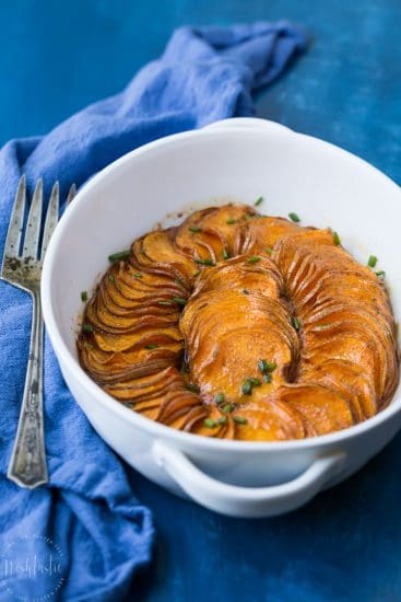 A gorgeous Paleo Scalloped Sweet Potato recipe that's both quick and easy to make, tastes great, and looks fantastic! It's perfect for your Thanksgiving table. #paleo #paleosweetpotatoes #paleothanksgiving #paleosides #paleodinner #paleorecipe #glutenfreethanksgiving #maplesyrup