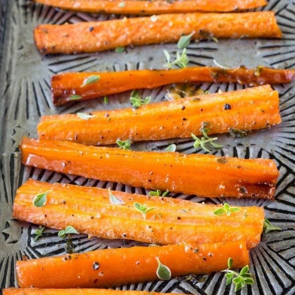 Quick and easy Paleo glazed carrots made with honey, olive oil and fresh thyme. You can cook them on the stovetop or bake them in the oven! #paleo #paleosides #paleocarrots #glutenfree