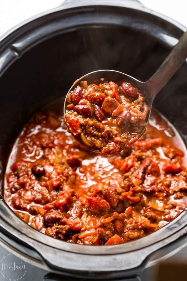 Slow Cooker Chili recipe - easy to make, this Crockpot chili is bursting with flavor and combines Ancho chili powder and fire roasted tomatoes to create an amazing flavor combination! #chilirecipe #crockpotrecipes #slowcookerrecipes #chiliconcarne #beefrecipes #beefchilirecipes #groundbeef #glutenfree #noshtastic