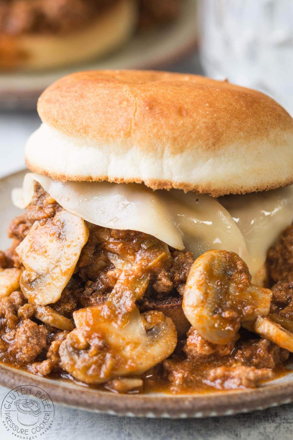 closeup of ground beef, mushrooms and cheese on gluten free bread