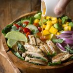 Chicken Avocado Salad with Honey Lime Dressing is such a fun summer salad! It's jam packed with healthy ingredients including arugula, spinach, and mango.| www.noshtastic.com | #chickensalad #chickenavocadosalad #glutenfreesalad #paleo #paleosalad #paleochicken #healthysalad #glutenfree #noshtastic #glutenfreerecipe