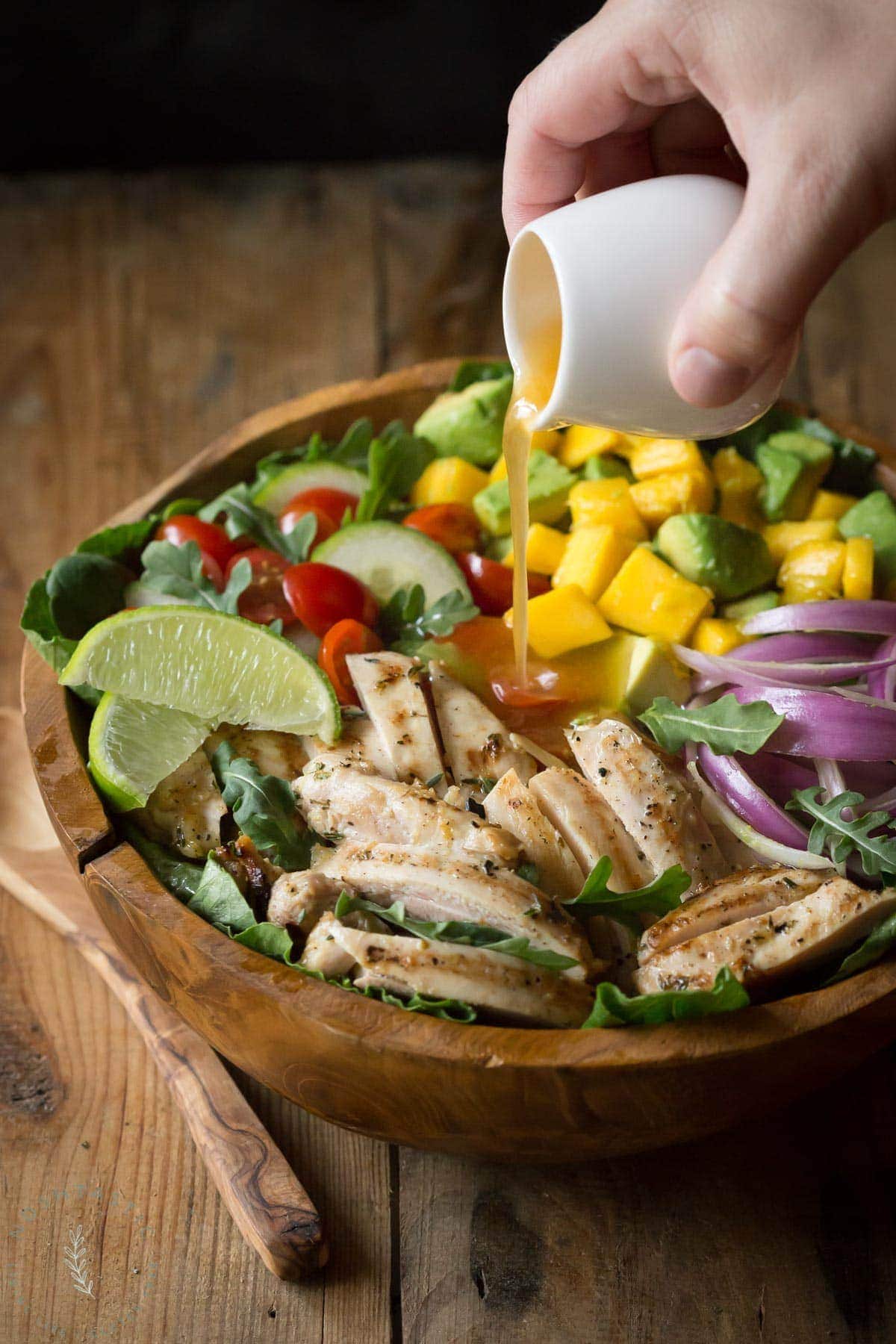 Chicken Avocado Salad with Honey Lime Dressing is such a fun summer salad! It's jam packed with healthy ingredients including arugula, spinach, and mango.| www.noshtastic.com | #chickensalad #chickenavocadosalad #glutenfreesalad #paleo #paleosalad #paleochicken #healthysalad #glutenfree #noshtastic #glutenfreerecipe 