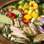 Chicken Avocado Salad with Honey Lime Dressing is such a fun summer salad! It's jam packed with healthy ingredients including arugula, spinach, and mango.| www.noshtastic.com | #chickensalad #chickenavocadosalad #glutenfreesalad #paleo #paleosalad #paleochicken #healthysalad #glutenfree #noshtastic #glutenfreerecipe