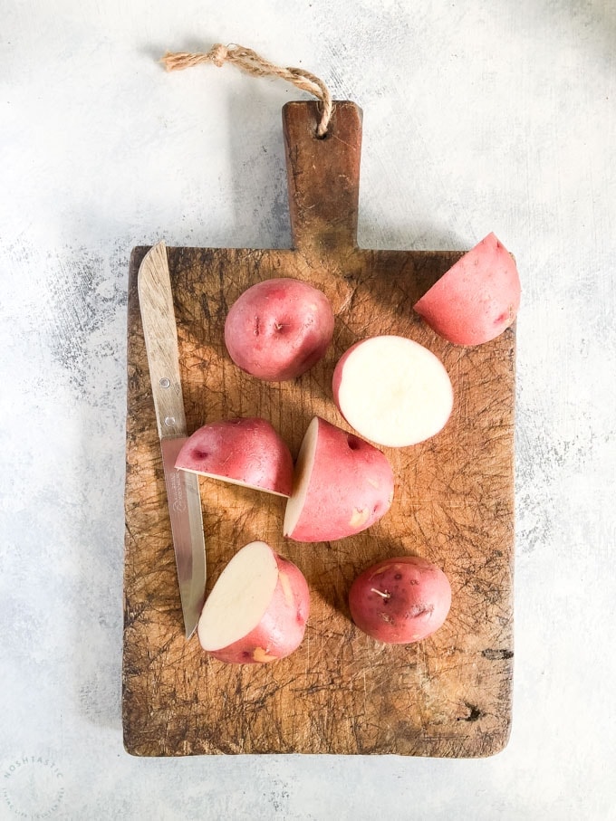 red potatoes on a cutting board