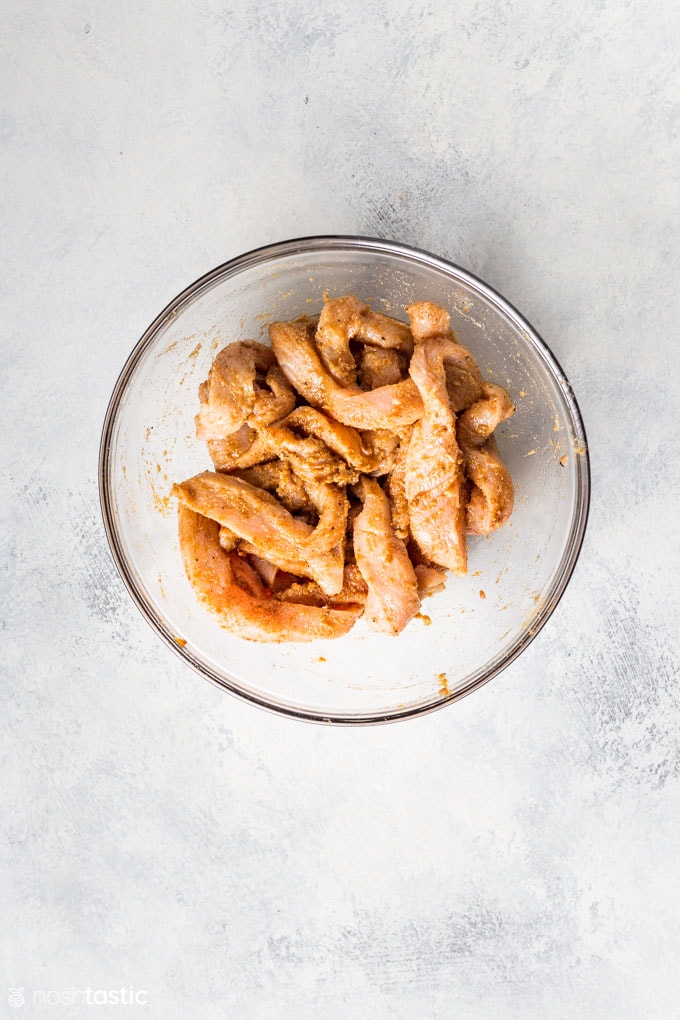 chicken marinating in a bowl