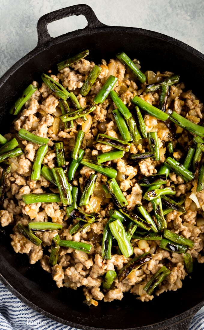 pork stir fry with green beans in a skillet