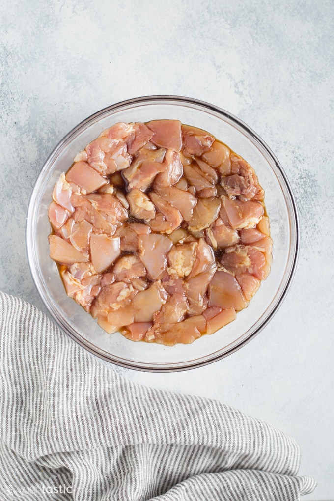 chicken marinating in a bowl