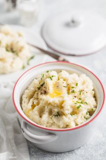 cauliflower mash in a bowl with melted butter on top