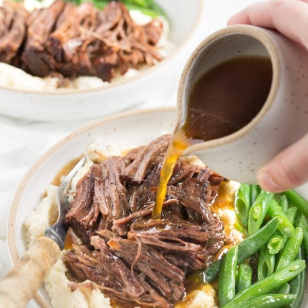 Pot roast in a bowl with green beans and gravy