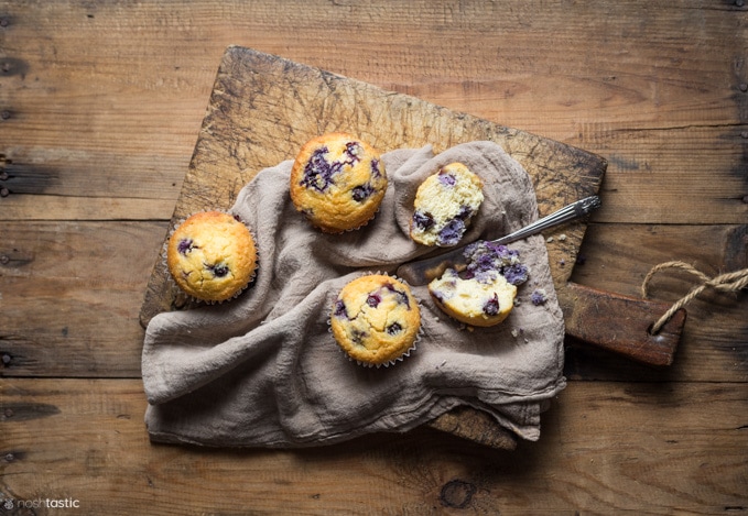 Low carb blueberry muffins cut in half on a board