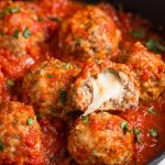 Mozzarella meatballs in a cast iron skillet with marinara sauce