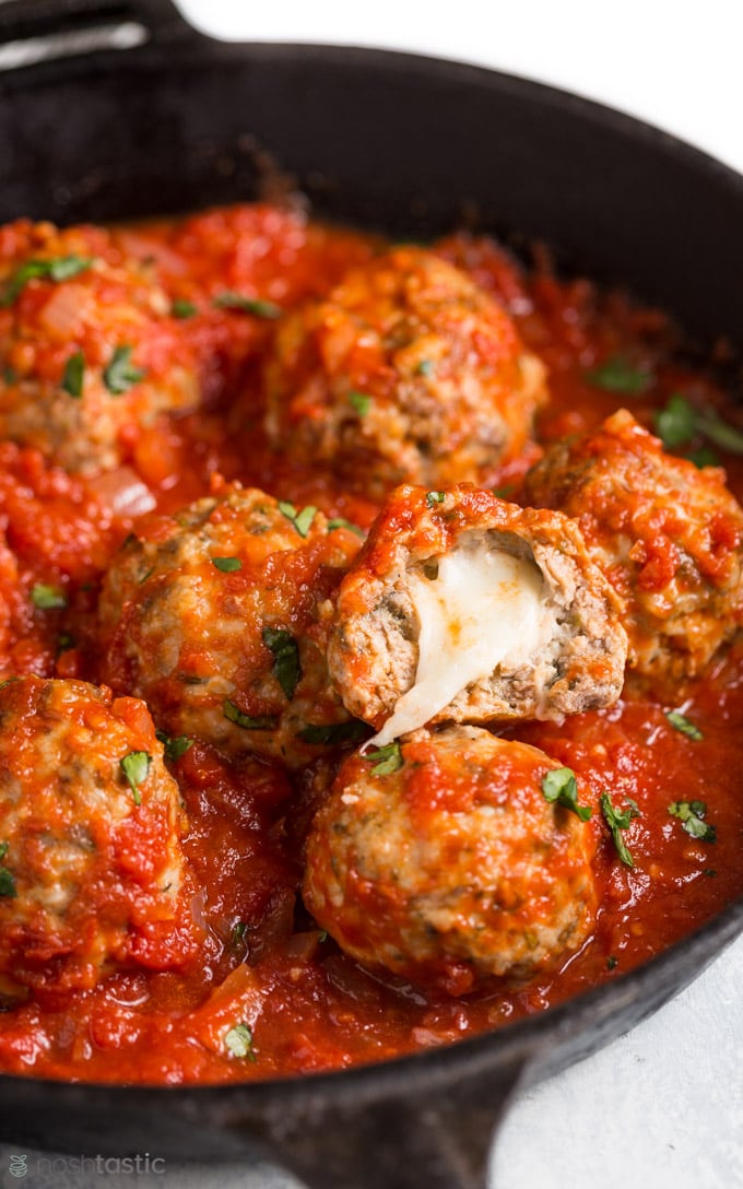 Mozzarella meatballs in a cast iron skillet with marinara sauce