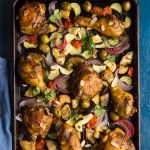 Chicken pieces with spices cooked on a sheet pan with vegetables