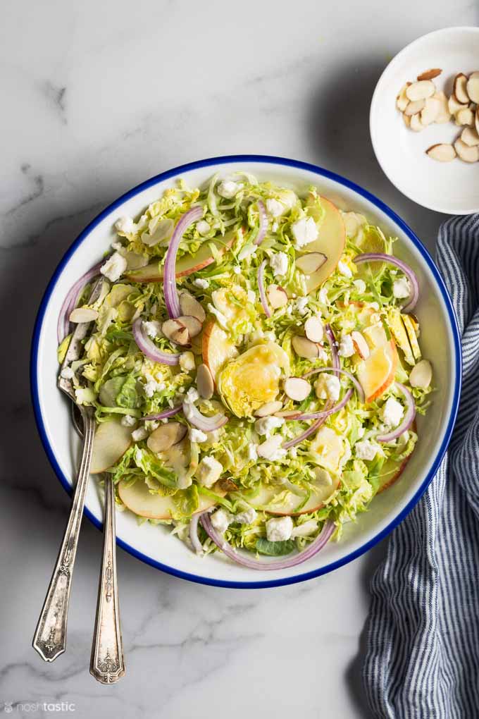 Shaved brussels sprouts salad in a bowl with a honey mustard dressing