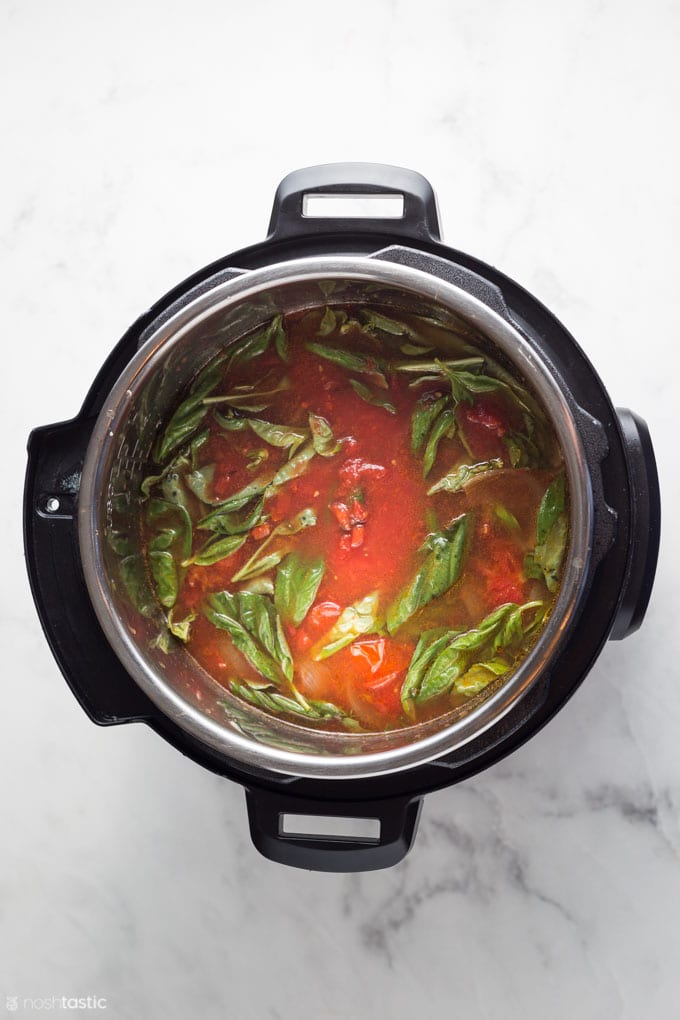 ingredients in an instant pot for making tomato basil soup