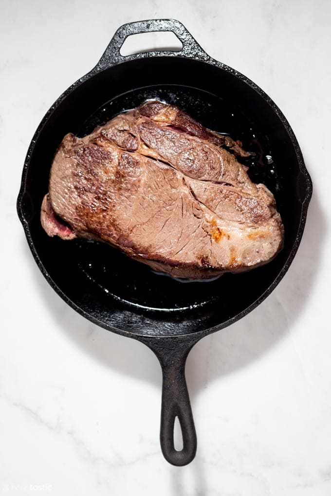 browned chuck roast in a skillet