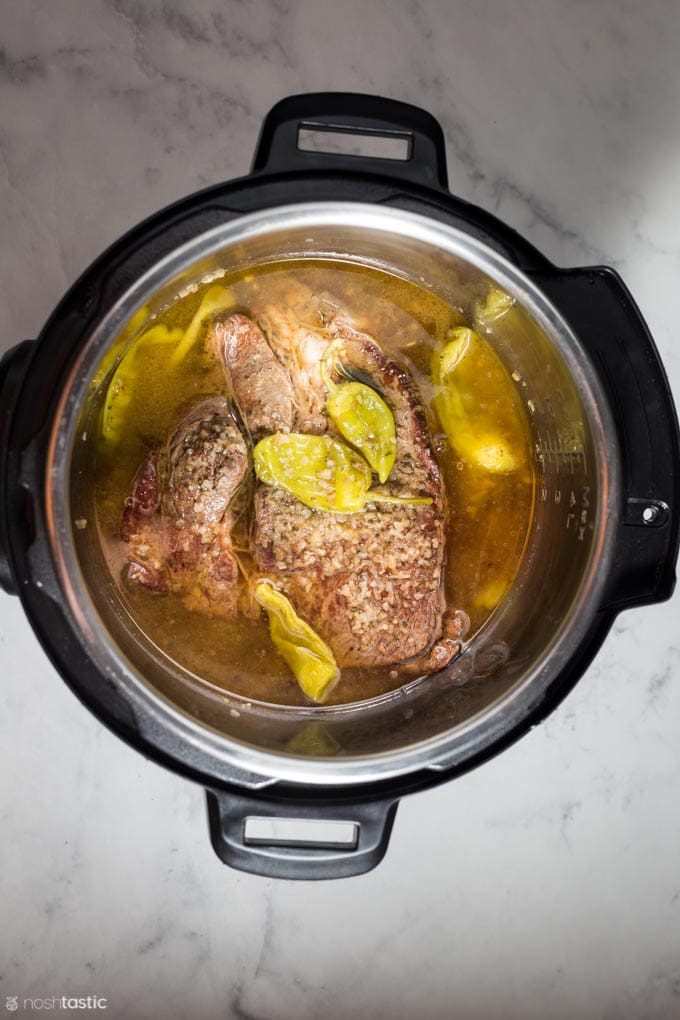 fully cooked mississippi pot roast in a pressure cooker