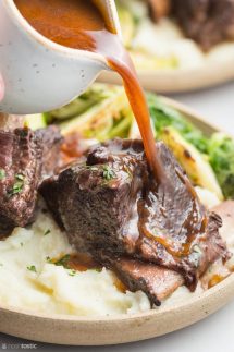 Instant pot short ribs on a plate with gravy poured over
