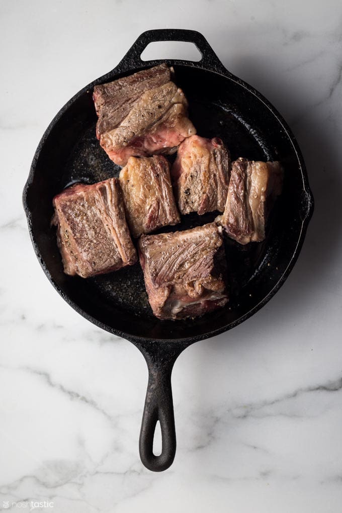 browned short ribs in a cast iron skillet