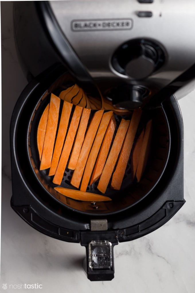 sweet potato fries in an air fryer basket