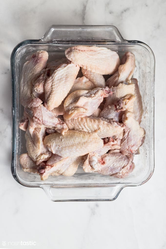 chicken wings in a glass dish