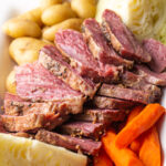 Sliced corned beef with cabbage, carrots, and potatoes