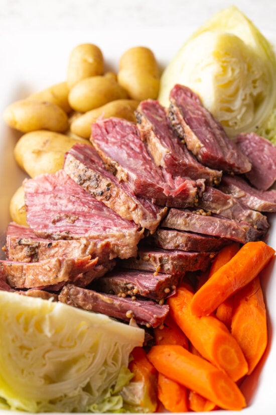 Sliced corned beef with cabbage, carrots, and potatoes
