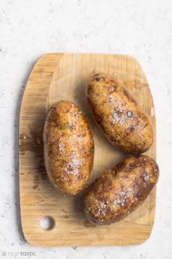 uncooked Russet Potatoes rubbed with olive oil and salt