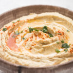 Hummus with paprika topping in a bowl