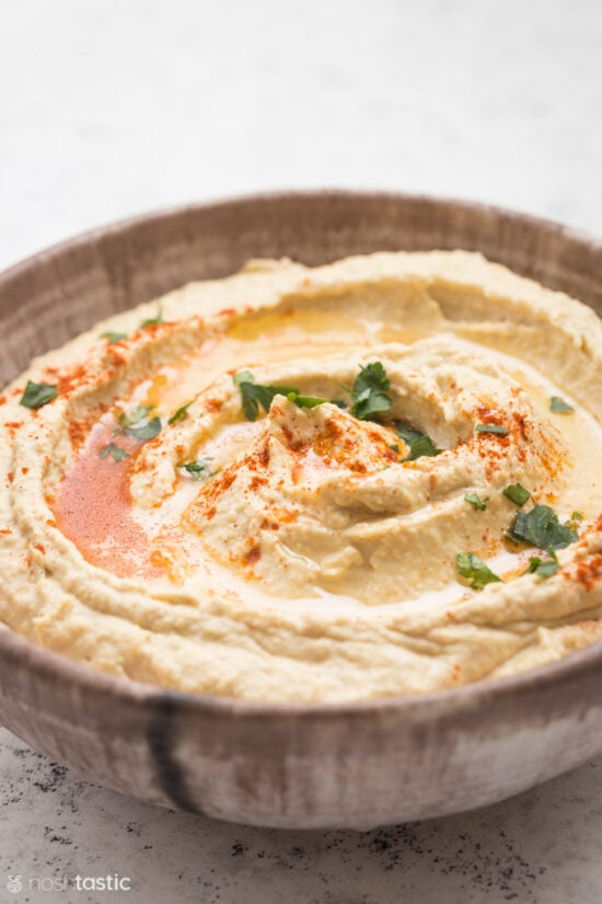 Hummus with paprika topping in a bowl