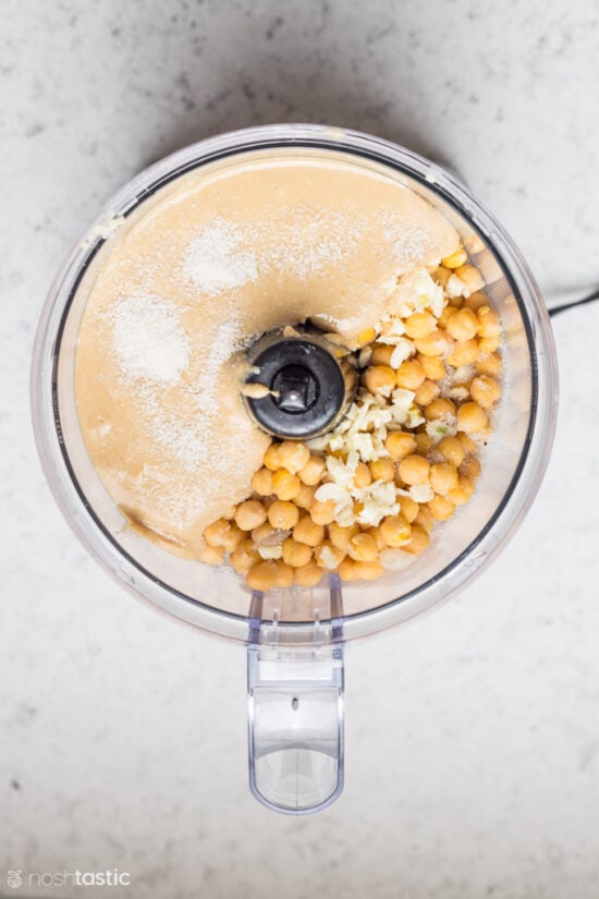 Tahini and cooked chick peas in a food processor